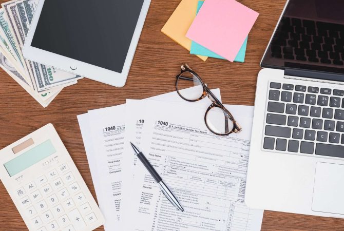top-view-of-tax-forms-digital-devices-and-stationery-on-desk.jpg